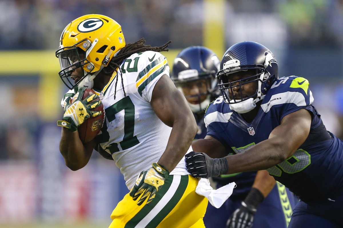 Eddie Lacy looks to avoid a tackle by Cliff Avril—Joe Nicholson, USA TODAY Sports.